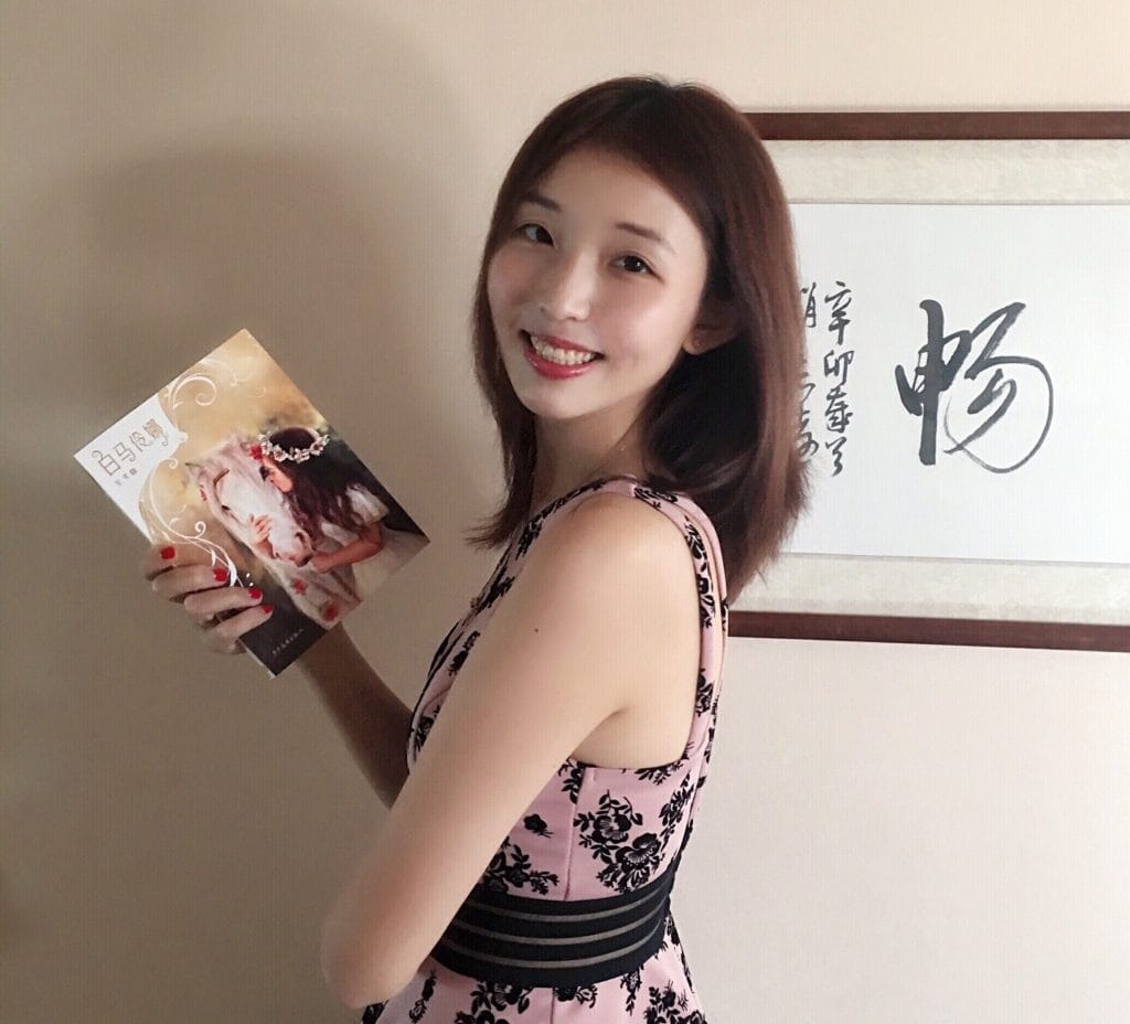 Di Bei holds a copy of her book