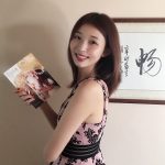 Di Bei holds a copy of her book