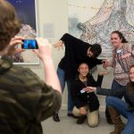 Students take photos and selfies with art in the Maier as part of a Science + Art Saturdays activity