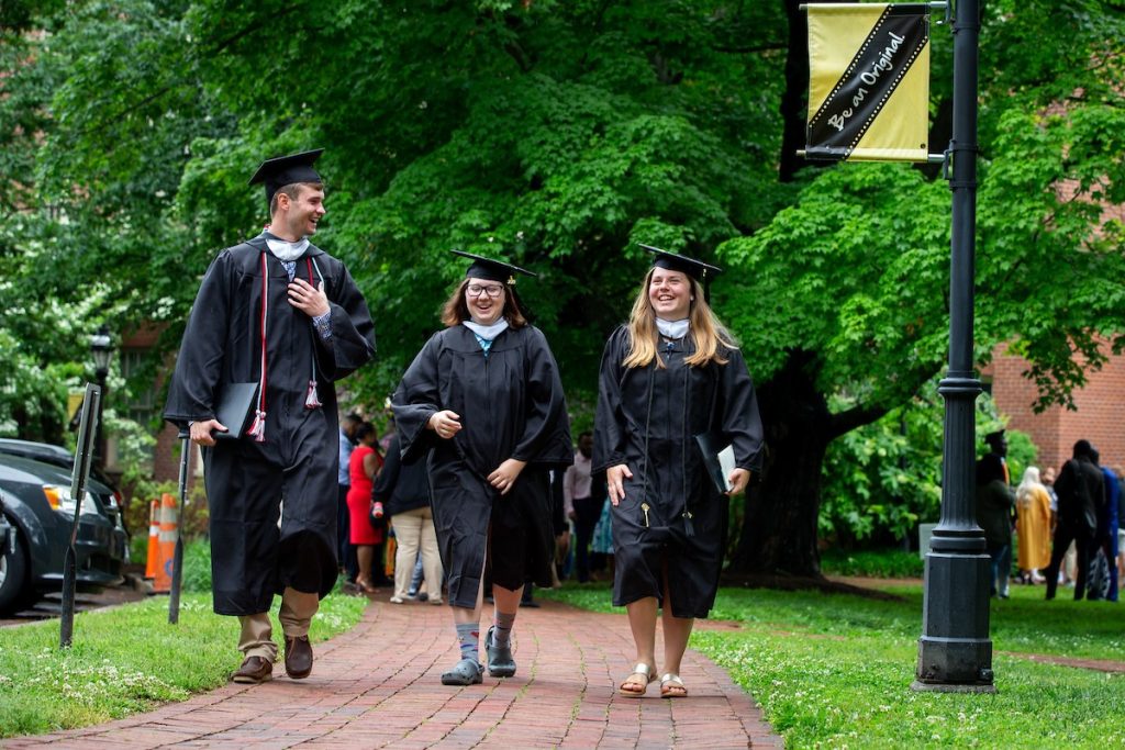 Graduates walk along the Red Brick Path on front campus Graduates walk along the Red Brick Path on front campus
