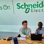 Anthony Fonnesu works with a colleague at Schneider Electric