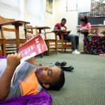 A Freedom School student reads a book during the program