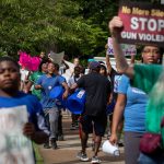 Students and volunteers participate in the march against gun violence down Rivermont Avenue