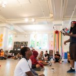 Nick George, founder and executive director of The Listening, Inc., reads from his poetry at the Freedom School.