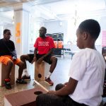 A student and servant-leader intern play the drums