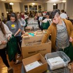 Students pack food during the Give Back event