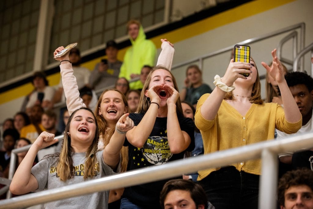 The student section cheers on the WildCats during a basketball game