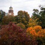 Trees pictured in full fall colors in front of Main Hall