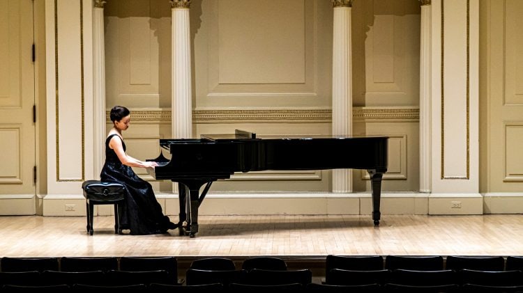 Emily Yap Chua warms up on piano prior to the recital