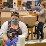 Biology lab technician Sara Harper and visiting biology professor Erin Heller put together lab kits for students taking Heller's zoology course this fall.