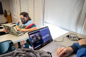 Mitchell Doss '21 and other in-person students connect with their virtual classmates during one of Warren's classes. 