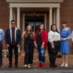 Graduating students pose for group photo on the steps of Main Hall.