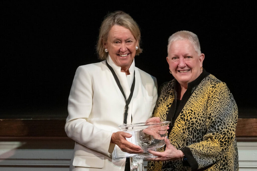 President Sue Ott Rowlands presents a bowl to Katharine "Kitty" Stark Caldwell '74 during the Alumni Achievement Award ceremony. 