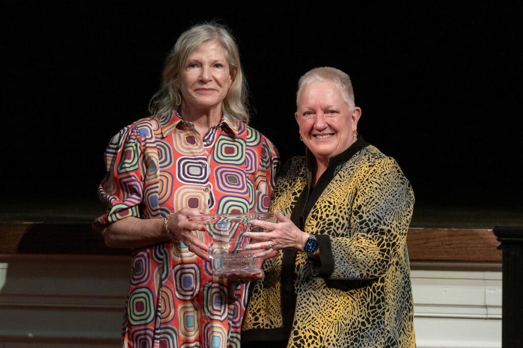 President Sue Ott Rowlands presents Diane "Misty" Matthews Walker '74 with a bowl during the Alumni Achievement Award ceremony. 