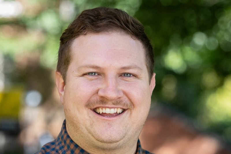 Portrait photo of Dustin Abernathy outside on front campus Portrait photo of Dustin Abernathy outside on front campus