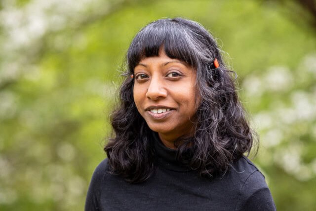 Portrait photo of artist Mita Mahato, standing outside
