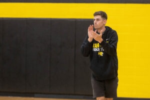 Men's volleyball coach Jordan Leandro claps his hands together during a recent practice. 