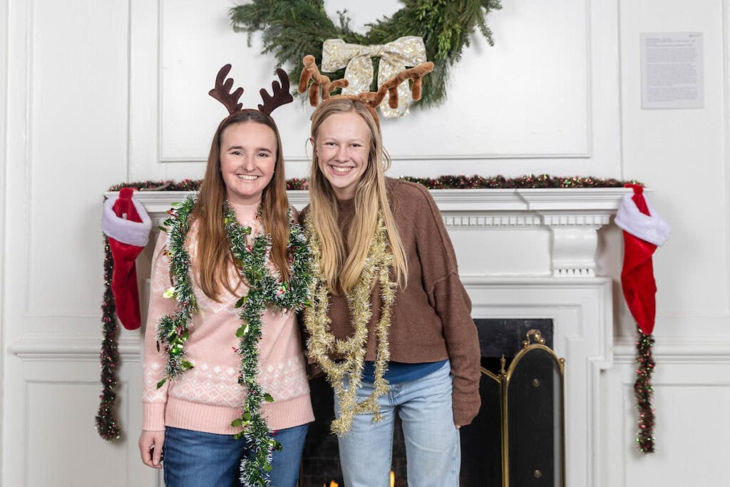 Students pose for photos in front of the fireplace at the annual Holiday on Main event.