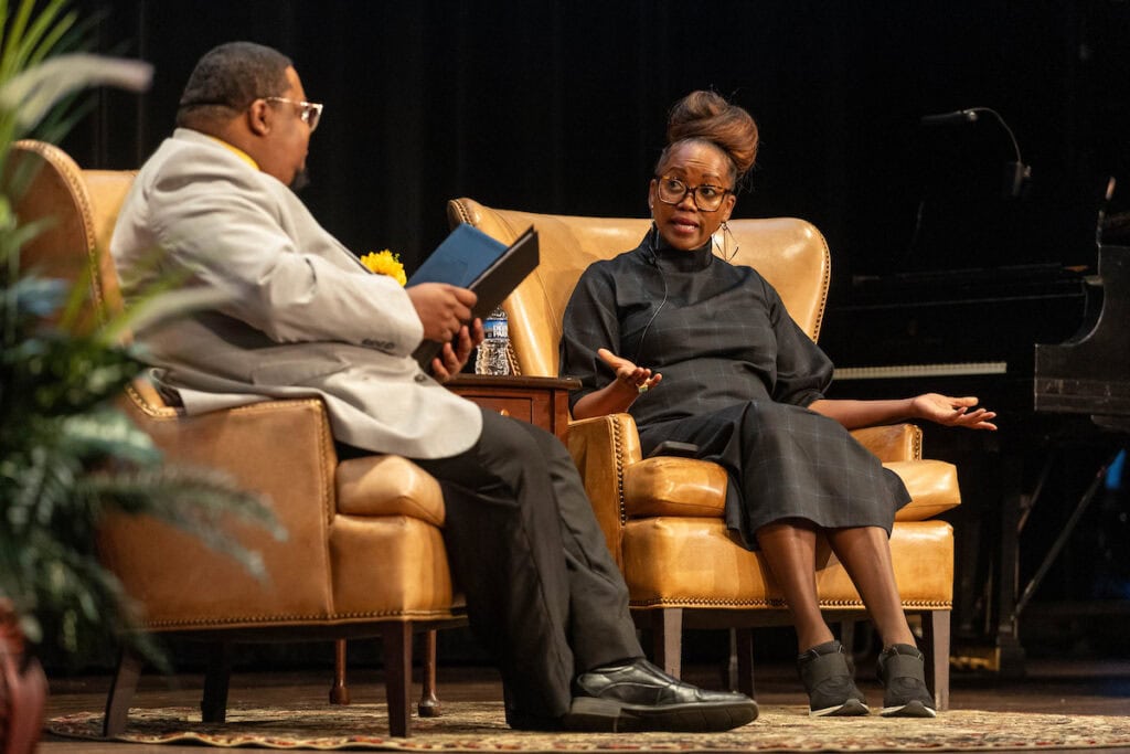 Actress and activist Erika Alexander sits onstage, talking to Chief Diversity Officer Charles Gibson III during Randolph College's annual MLK Celebration. Actress and activist Erika Alexander sits onstage, talking to Chief Diversity Officer Charles Gibson III during Randolph College's annual MLK Celebration.
