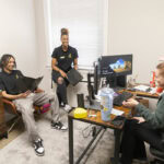 Cameron Goulde, Nafi Thiam, and Arielle Barfield meet in her office.
