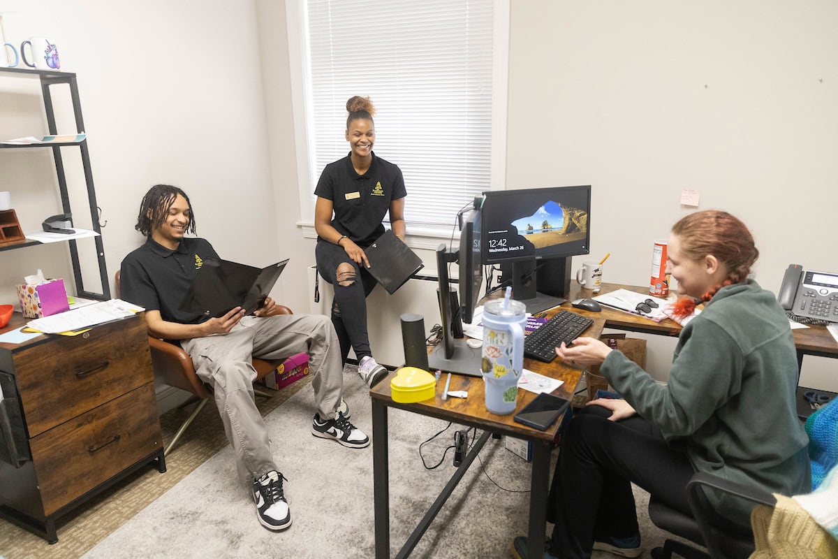 Cameron Goulde, Nafi Thiam, and Arielle Barfield meet in her office.