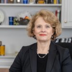 Photo of Farah Marks sitting at her desk