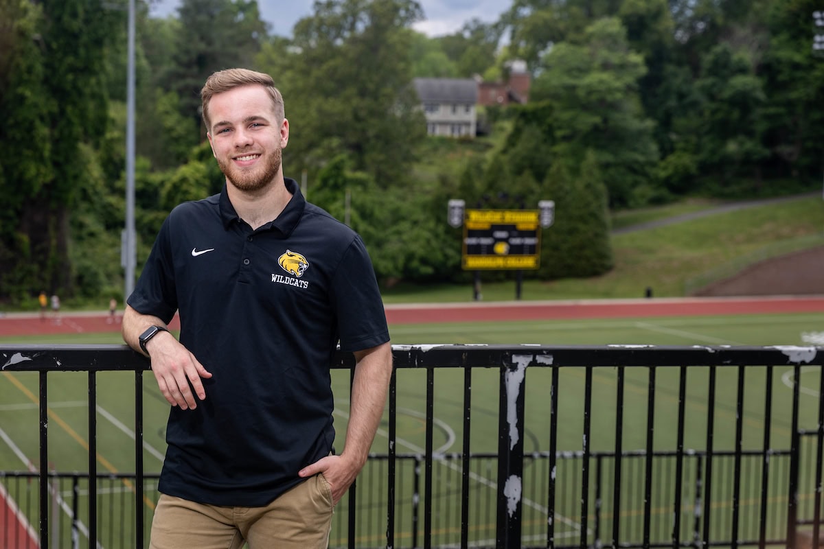 Zach Nipper poses for a photo in front of the Randolph soccer field. 