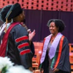 Jordyn Shumpert walks up to the stage during Randolph's 2025 Intercultural Baccalaurate. The event was held in Houston Memorial Chapel, which you can see in the background. She's smiling. Jordyn Shumpert walks up to the stage during Randolph's 2025 Intercultural Baccalaurate. The event was held in Houston Memorial Chapel, which you can see in the background. She's smiling.
