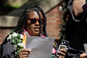 A student looks at a piece of paper with song lyrics during Daisy Chain