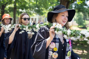 A group of seniors walks while holding the Daisy Chain