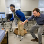 Andrew Hooks and professor Jonathan Skelton look and point at the College's 3D printer Andrew Hooks and professor Jonathan Skelton look and point at the College's 3D printer