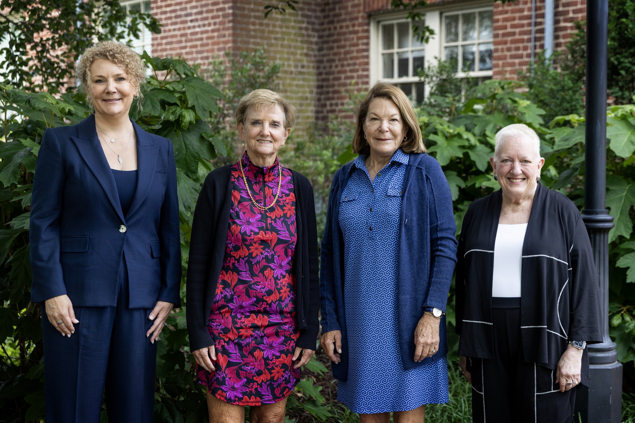 Stacey Robbins Kennedy ’95, Lesley Morgan ’75, and Alison Keller Townsend ’75 pose with President Sue Ott Rowlands after receiving the Alumni Achievement Award 