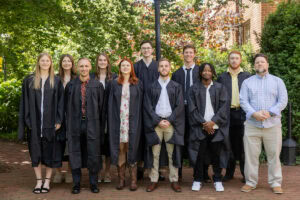 A group of Master of Arts in Coaching and Sport Leadership graduates pose together for a photo. 