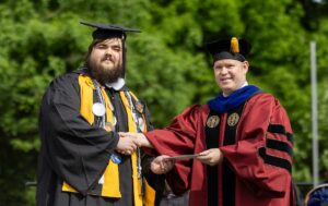 Luke Chapman receives the Maude Huff Fife Award from Provost Tim Smith