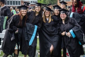 A group of graduates pose together for a photo 
