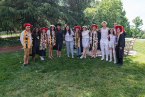 A group of seniors and sophomore pose together during the Daisy Chain ceremony on campus 