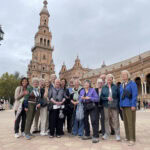 A group of alums pose in Plaza de Espana
