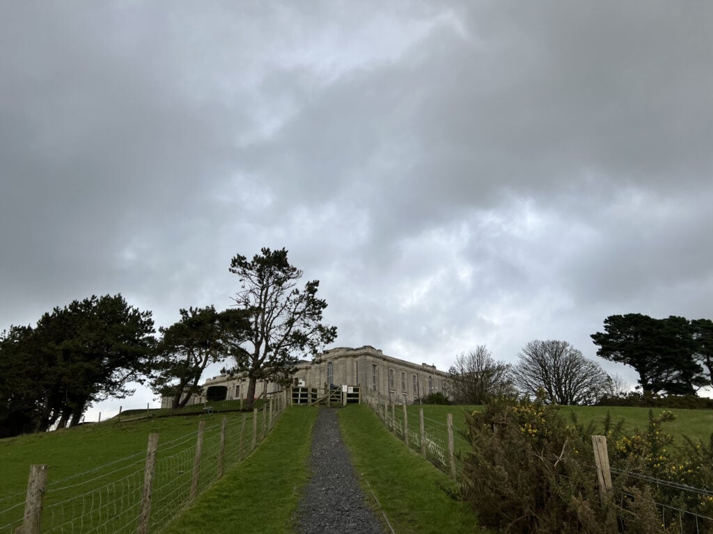 A wide shot of the National Library of Wales, taken down the winding path leading up to it 