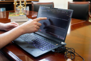 Someone points at the screen of a laptop 
