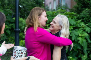 Two alums embrace while reuniting on campus