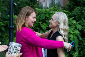 Two alums embrace while reuniting on campus