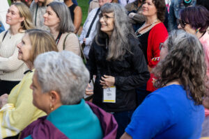 Alums listen in the crowd while professor Gerry Sherayko leads a walking tour on campus during Reunion