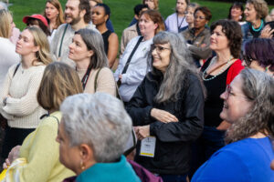 Alums listen in the crowd while professor Gerry Sherayko leads a walking tour on campus during Reunion