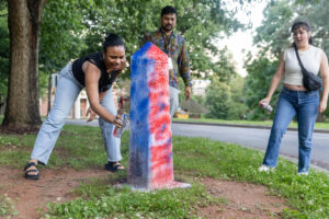 Alums spray paint the Even Post during Reunion