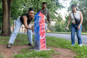 Alums spray paint the Even Post during Reunion