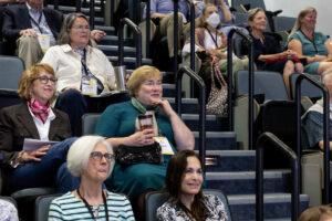 A group of people sitting in a lecture hall.