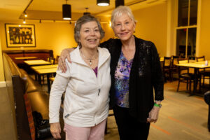 Two alums pose for a photo together during Reunion