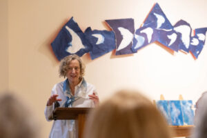Ann Holsberry speaks to fellow alums about her Maier exhibit during Reunion