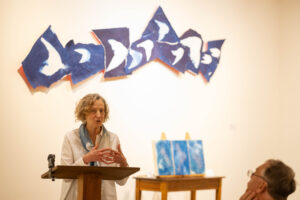 Ann Holsberry speaks to fellow alums about her Maier exhibit during Reunion