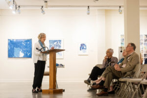 Ann Holsberry speaks to fellow alums about her Maier exhibit during Reunion